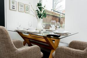 a dining room with a glass table and two chairs at Free Parking - Large House - Contractor - Leisure in Birmingham