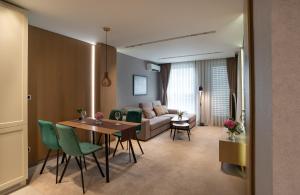 a living room with a table and a couch at City Park Inn Apartment Cortona in Plovdiv