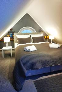 a bedroom with a large bed with two towels on it at Apartments mit Flair in Fehmarn