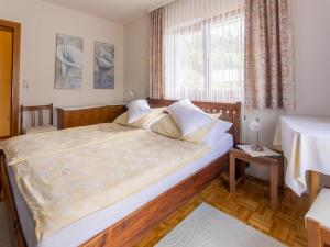 a bedroom with a large bed and a window at Tranquil Holiday Home in Aywaille with bubble bath in Seeboden
