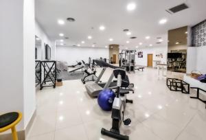 a gym with cardio equipment in the middle of a room at Epsilon Hotel Apartments in Faliraki