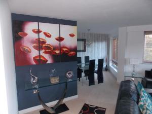 a living room with a couch and a dining room at Waterside Apartment in Lancaster