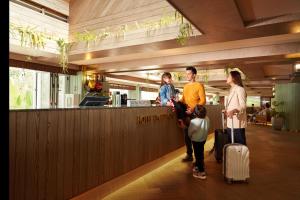 a group of people standing at a bar with luggage at Resorts World Awana in Genting Highlands