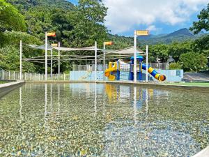 a water park with a water slide in the water at Lapopo in Keelung