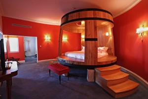a bedroom with a large bed with a large mirror at The Yeatman in Vila Nova de Gaia