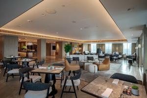 a restaurant with tables and chairs and a lobby at New World Saigon Hotel in Ho Chi Minh City