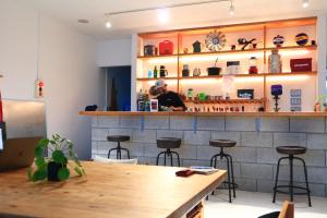 a man sitting at the bar in a restaurant at guest house Active Life -YADO- in Ishinomaki