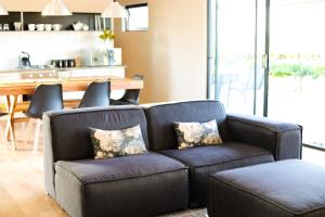 a couch and a chair in a living room at STEYNMOND COTTAGE in Kakamas +13 photos