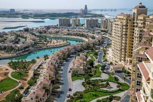an aerial view of a city with a river and buildings at Hala Holiday Homes - Al Hamra Village, RAK in Ras al Khaimah