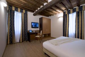En eller flere senge i et værelse på CDH Hotel Villa Ducale