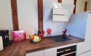 a kitchen with a sink and a bowl of fruit on a counter at Donauhosting, Stadt Land Fluss in Unterkirchberg