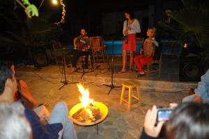 a group of people sitting around a fire at Olympos Koyevi Countryhouse in Olympos +137 photos