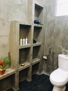 a bathroom with a toilet and a shower at Ceagull in Ahangama