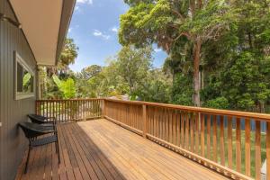 a wooden deck with a chair on a house at The Royal Cuban in Elizabeth Beach