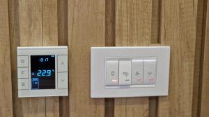 an alarm clock and a clock on a wall at Xenia Apartment in Kopaonik