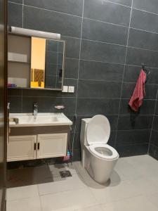 a bathroom with a toilet and a sink and a mirror at Bahria Residency in Rawalpindi