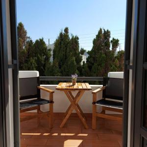 a patio with a table and two chairs on a balcony at Villa Del Mar in Antiparos Town