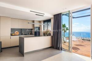 a kitchen with a view of the ocean at Avitan Premium & Luxury Villas in Adeje