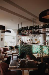a restaurant with tables and chairs and a bar at Le Rose Thé in La Ciotat