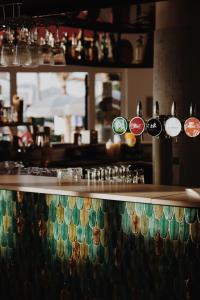 a bar with a counter with stickers on it at Le Rose Thé in La Ciotat