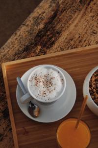 a cup of coffee on a plate on a tray at Le Rose Thé in La Ciotat
