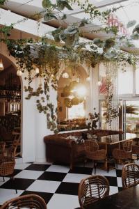 a restaurant with a checkered floor and tables and chairs at Rose Thé in La Ciotat