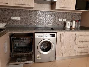 a kitchen with a dishwasher and a washer at Villa D60 in Sharm El Sheikh