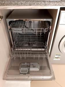 an empty dishwasher with its door open at Villa D60 in Sharm El Sheikh