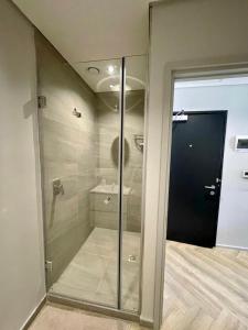a walk in shower with a glass door in a bathroom at 1728 at One Thibault in Cape Town