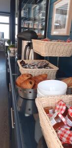 a bakery with baskets of bread and pastries on a counter at L'Huitrière in Quiberville