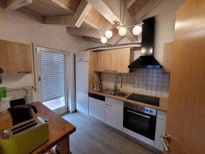 a kitchen with a table and a sink and a stove at Ferienwohnung Hegau in Hilzingen