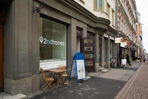 a store with a sign on the side of a street at 2ndhomes Pietarinkatu Apartment 2 in Helsinki