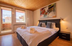 a bedroom with a large bed with two boxes on it at Miraflor Rosita - Arosa Holiday in Arosa