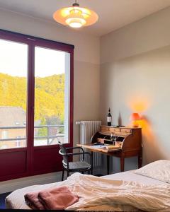a bedroom with a bed and a desk and a window at Villa Michaux in Hastière-par-delà +82 photos
