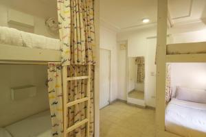 a bedroom with two bunk beds and a bed at Moustache Hostel, Jaipur in Jaipur