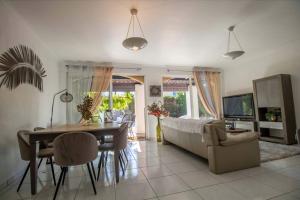 a living room with a couch and a table at Quiet villa with garden and terrace in Fréjus in Fréjus
