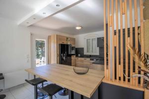 a kitchen with a wooden table and chairs at Quiet villa with garden and terrace in Fréjus in Fréjus