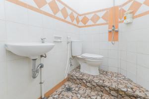 a bathroom with a toilet and a sink at RedDoorz Syariah at Mojosari in Mojokerto