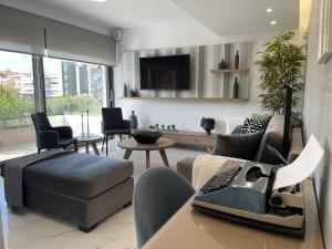 A television and/or entertainment centre at The Lop Athens Holidays Luxury Suites