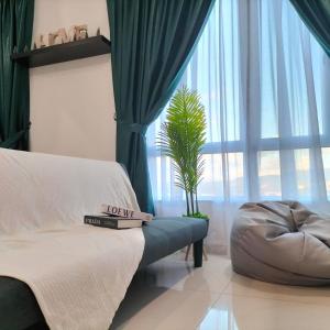 a bedroom with a couch and a large window at Mahkota Valley Apartment Indera Mahkota Kuantan#Netflix in Kuantan