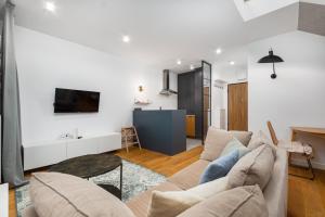 a living room with a couch and a table at Pory 57 by Homeprime in Warsaw