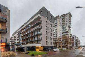 a large apartment building on a city street at Pory 57 by Homeprime in Warsaw