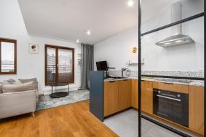 a living room with a couch and a kitchen at Pory 57 by Homeprime in Warsaw
