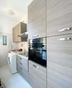 a kitchen with stainless steel cabinets and a stove at Milano Holiday & Work House - Duomo in Milan