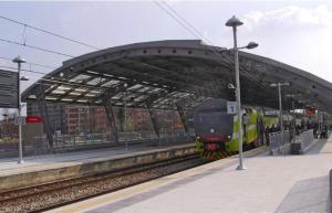 a train is pulling into a train station at Milano Holiday & Work House - Duomo in Milan