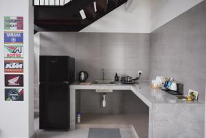 a kitchen with a sink and a refrigerator at Loft Style Duplex w/ Ultimate lakeview @ Sawtelle in Cyberjaya