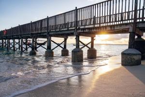 a pier on the beach near the water at The Residence Zanzibar in Kizimkazi