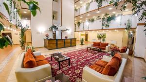 a large lobby with couches and a living room at Reikartz Dostar Karaganda in Karagandy