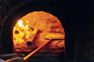a brick oven with a pizza in it at The Residence Zanzibar in Kizimkazi