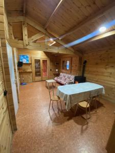 a room with a table and chairs in it at Bungalow & Camping Fuente De Regrustan in Graus